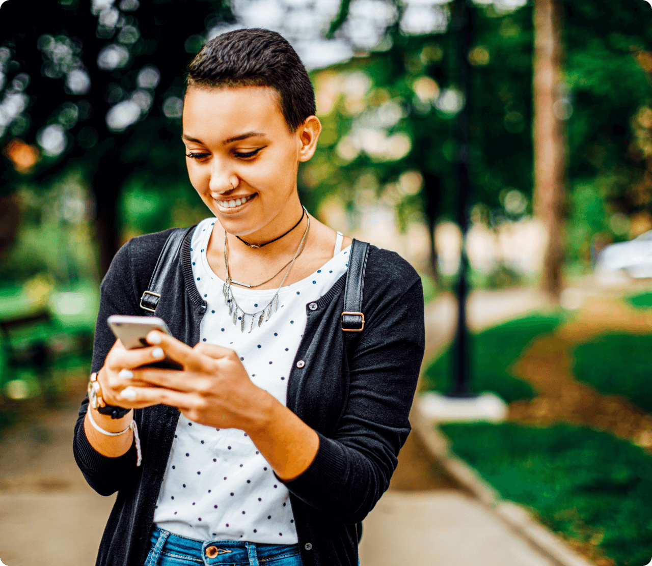 Woman smiling looking down at phone