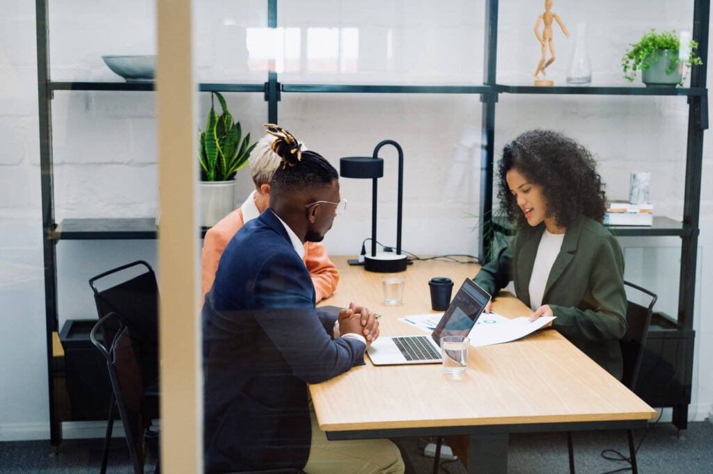 Businessman and businesswomen meet up and discuss various business prospects in a workspace