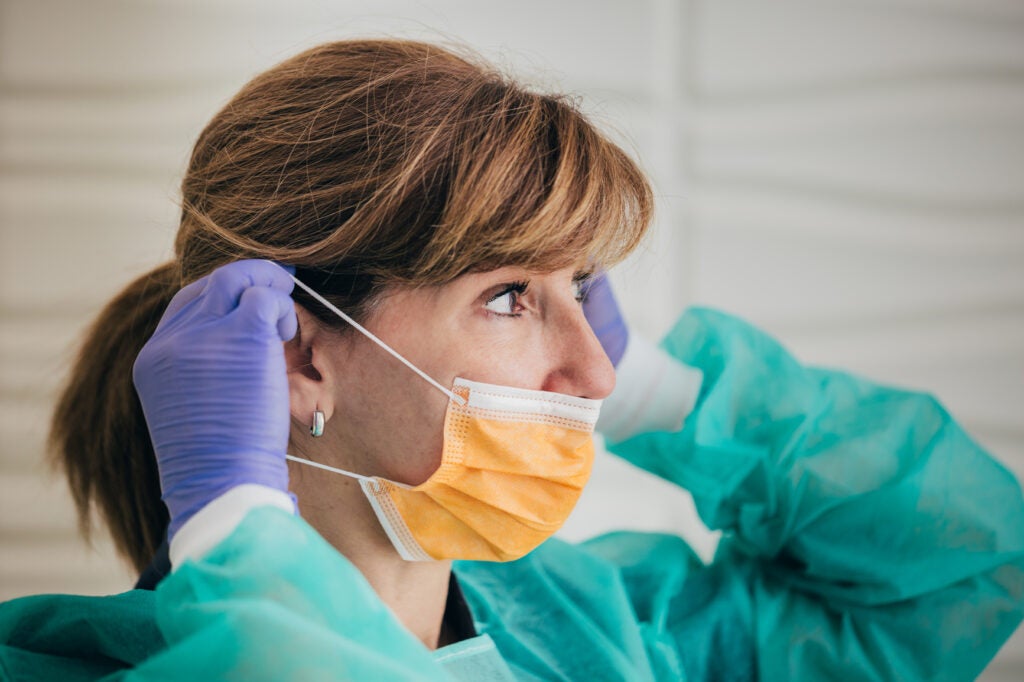 Surgeon adjusting the mask